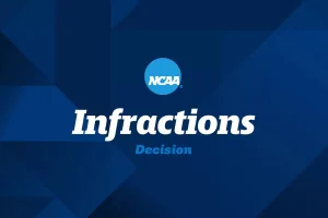 Former North Carolina A&T players ruled ineligible during NCAA betting investigation. NCAA Infractions Decision title slide with blue geometric background and NCAA logo centered above the words “Infractions Decision.”