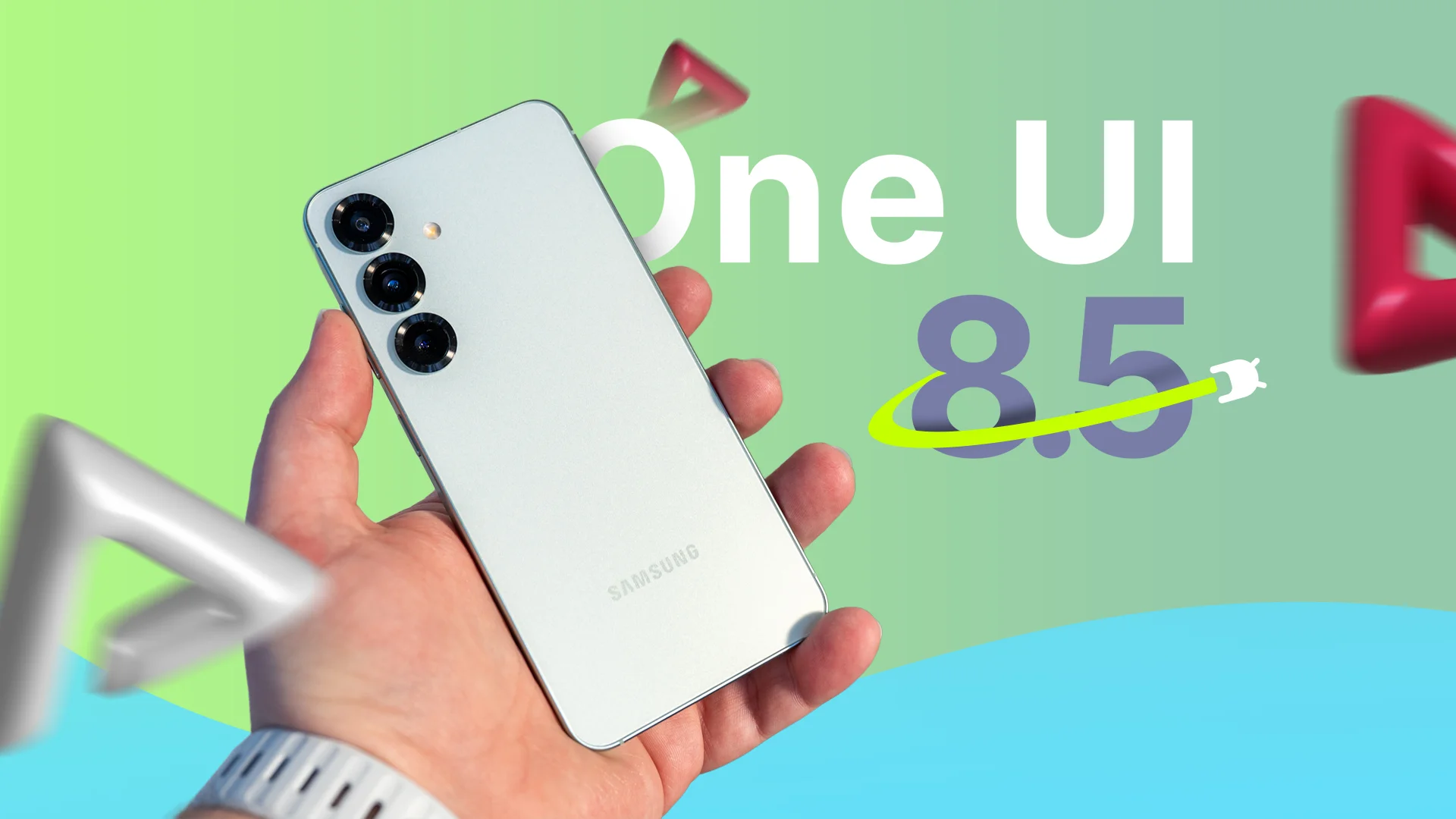 A hand holding a Samsung Galaxy s25, with 'One UI 8.5' displayed beside it.