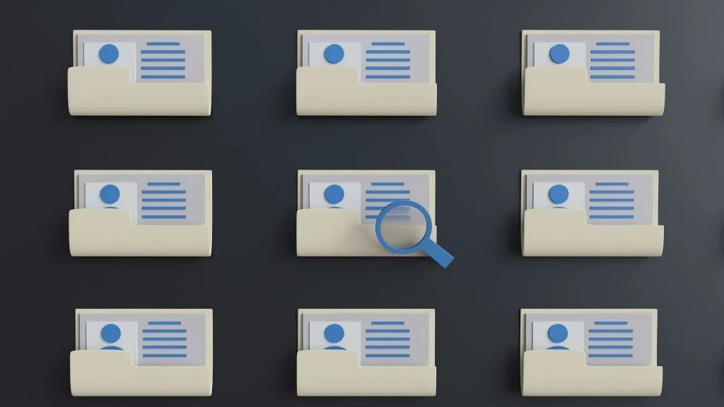 A 3D digital illustration featuring a 3x3 grid of beige file folders on a dark grey background. Each folder contains a document with a blue profile icon and horizontal lines, resembling a digital ID or record. A blue magnifying glass hovers over the center folder, symbolizing a search, data inspection, or selection process.
