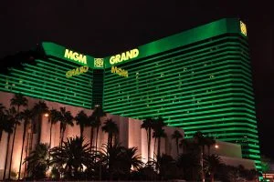 Exterior of MGM Grand hotel in Las Vegas, a green light has been shone on the building. Palm trees are lined in front. MGM Resorts third-quarter financial report is in, with China seeing a rise. MGM Resorts reports profit growth in Q4 2025